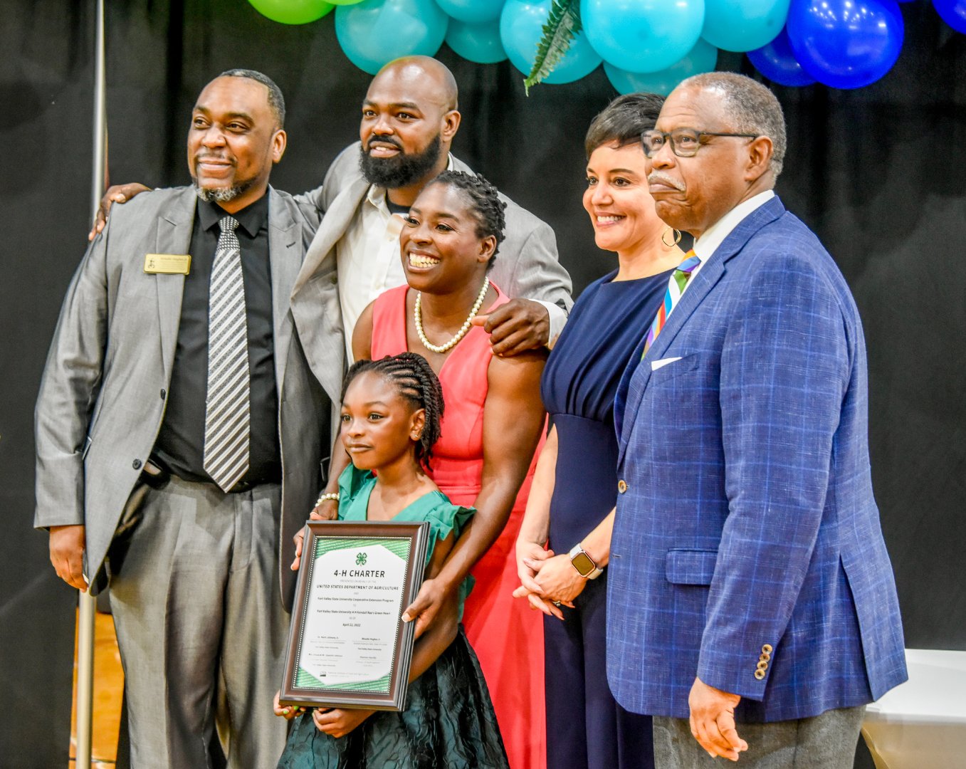 Kendall receives the 4-H Charter, along with Woodie Hughes Jr., assistant Extension administrator state 4-H program leader; her parents; Dr. Jewel Bronaugh, deputy secretary of agriculture; and Dr. Mark Latimore Jr., Extension administrator.