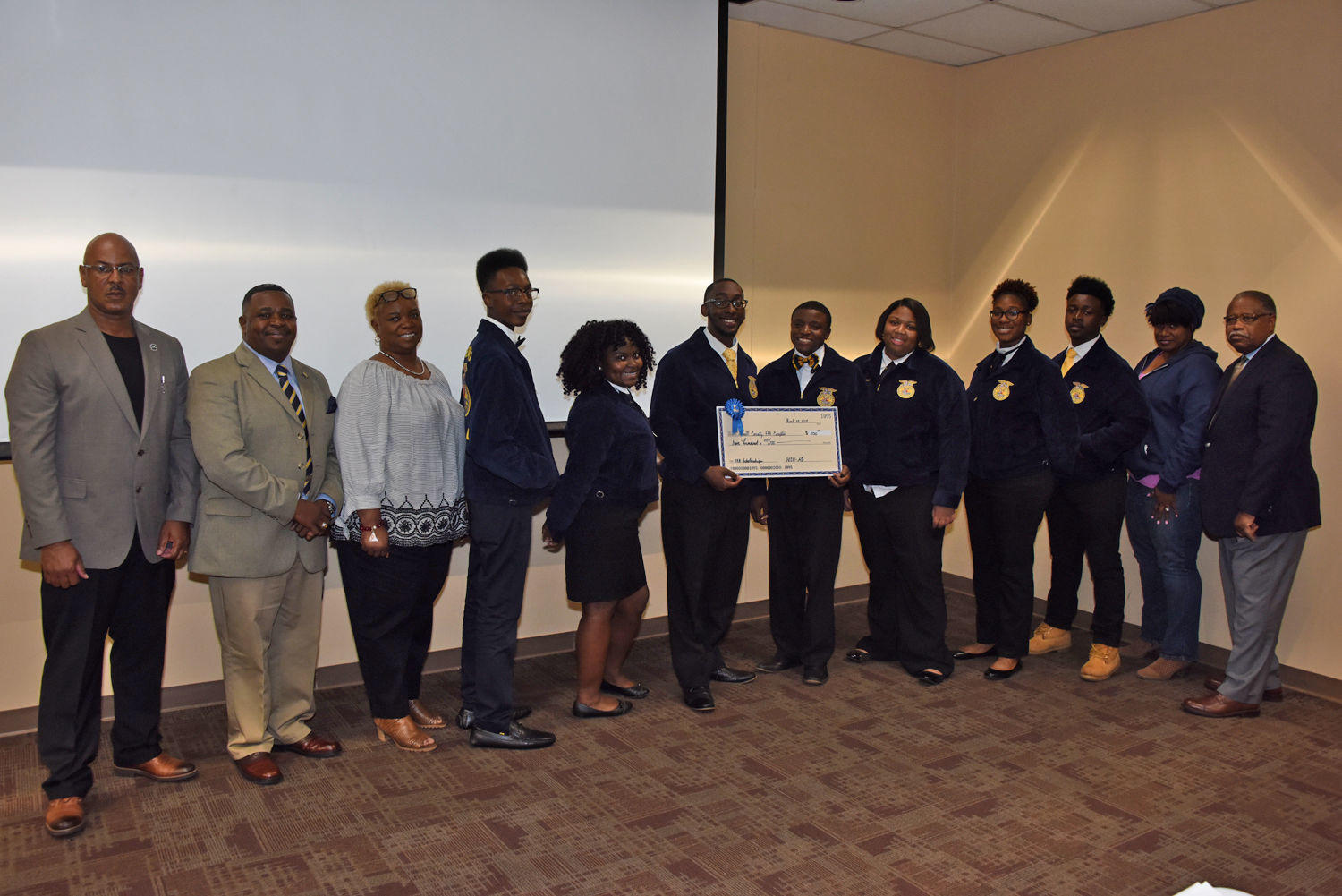 Charlie Grace (far left), FVSU Dougherty County Extension agent along with FVSU Terrell County Extension agent Atonya Jordan (second from right) and Dr. Mark Latimore Jr. (far right), FVSU Extension Administrator, present the Terrell County High School FF