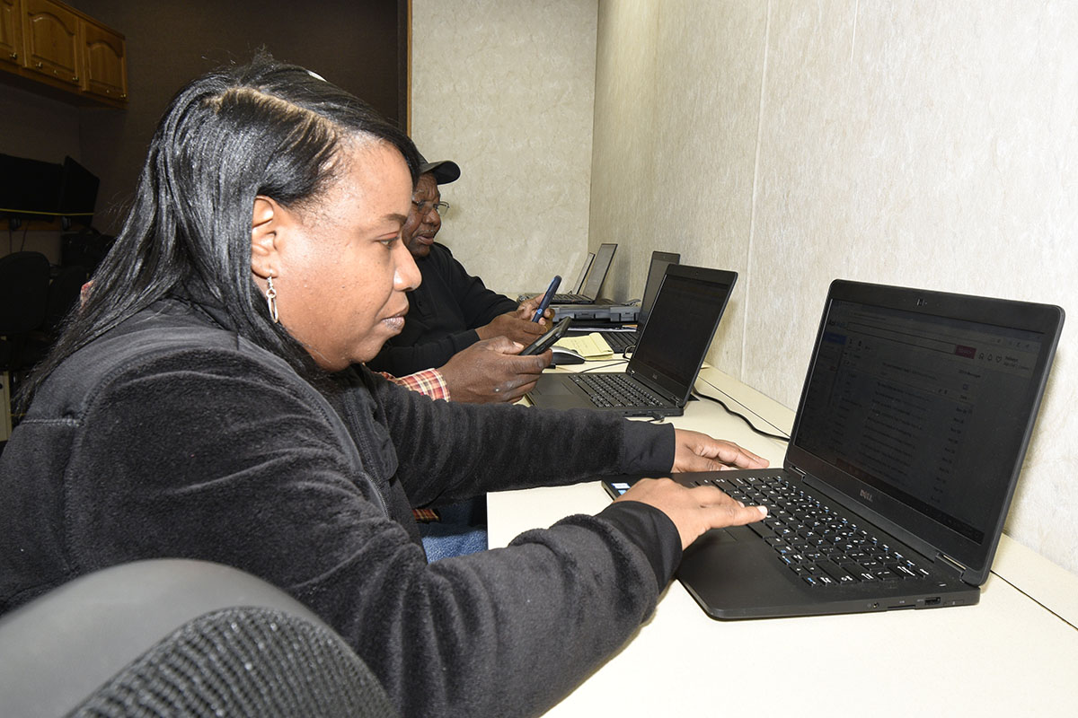 Chiquita Holsey, a farmer from Leesburg, completes an exercise on a laptop during the Mobile Device Integration Technology Learning Workshop.