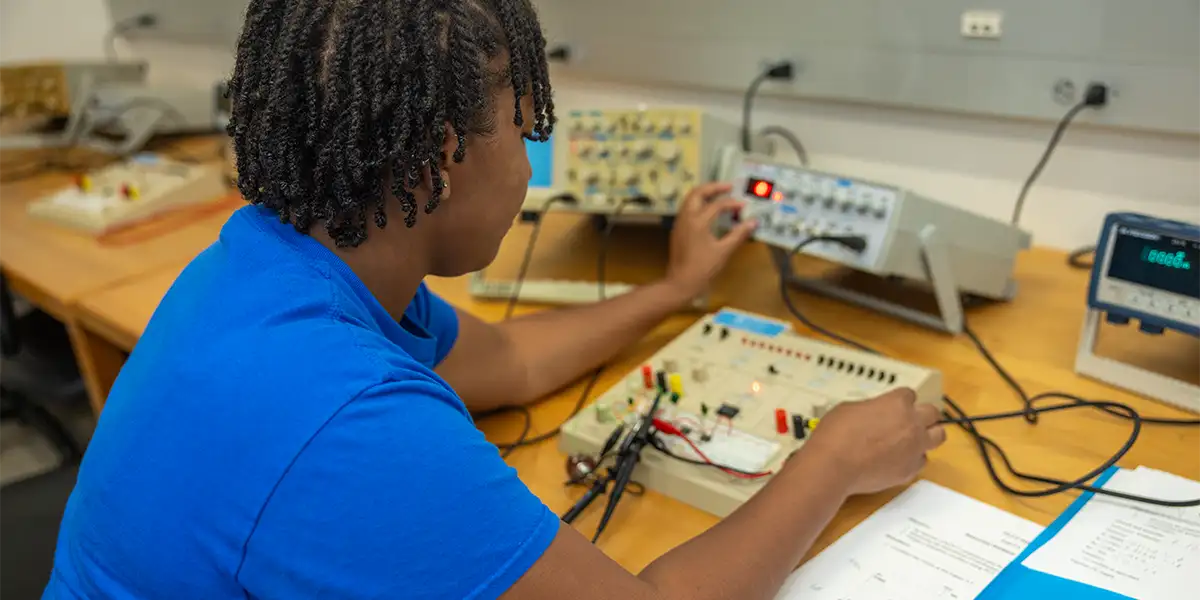 EET student working with electronic equipment in the lab.
