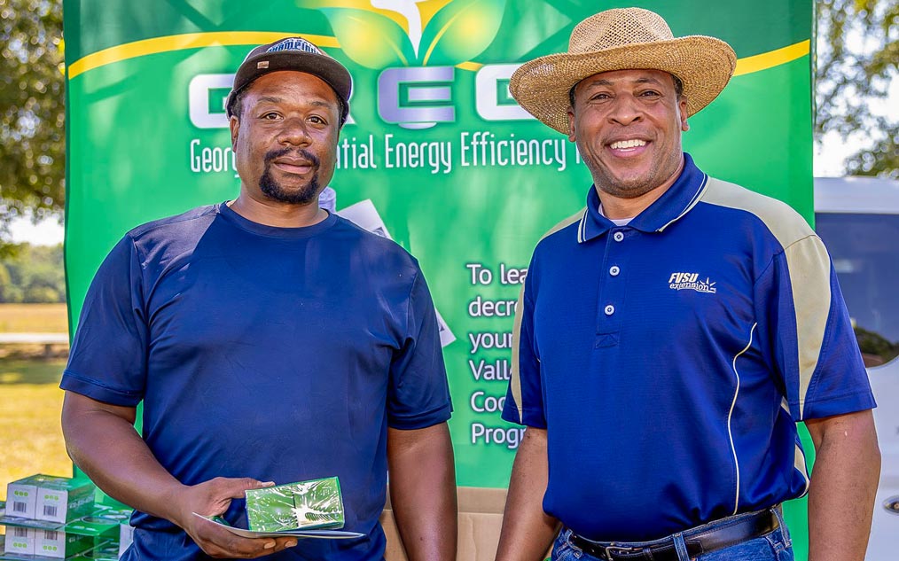 FVSU Energy Educator, Billy Brown, stands with an FVSU extension client holding an energy efficient LED bulb.