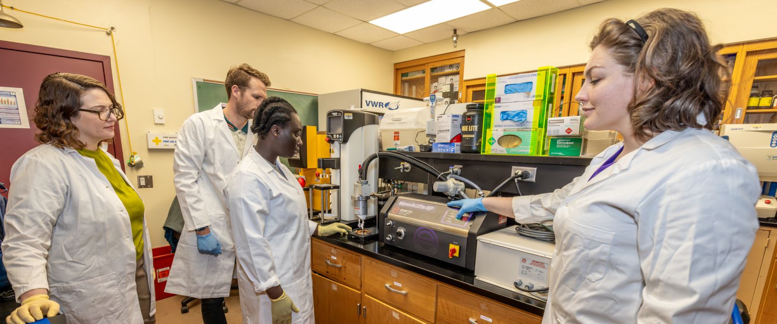 Graduate Vera Arthur and researchers from the Southeastern Fruit and Tree Nut Research Station of the U.S. Department of Agriculture’s Agricultural Research Service work in the lab on Fort Valley State University’s campus.