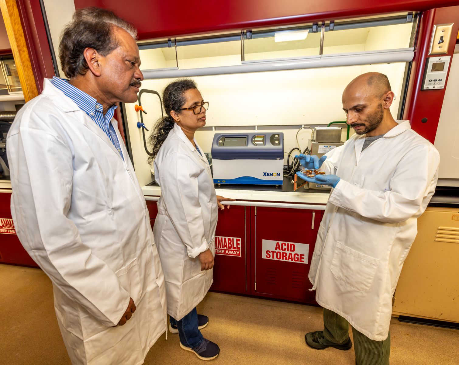 Researchers Ajit Mahapatra, Ph.D., Rabin Gyawali, Ph.D., and Hema Degala use intense pulsed UV light to decontaminate pecans in the FVSU Food Engineering Laboratory.