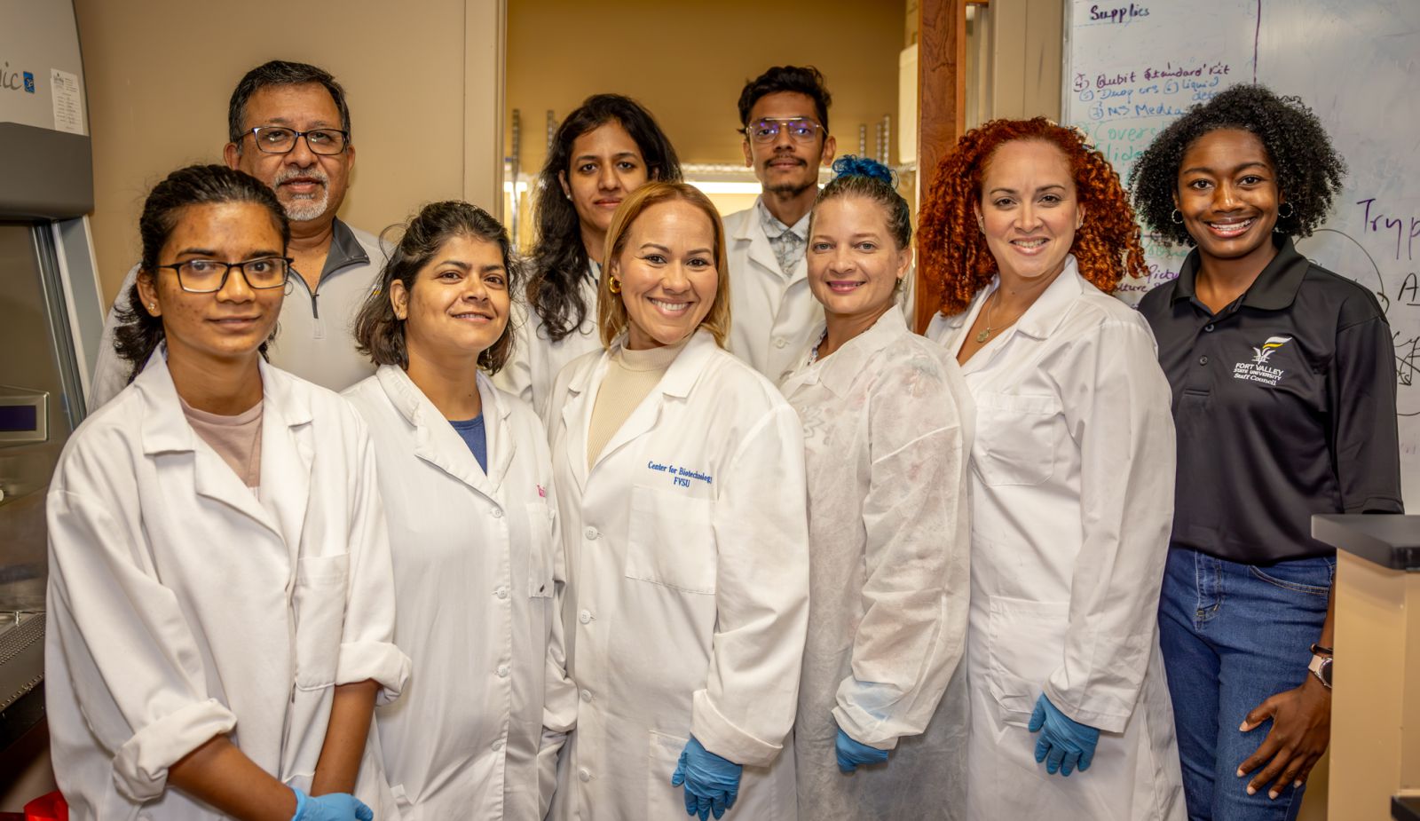 Science educators Natcha Leòn Lugo, Iriana Rosario Fontànez and Monica Pagàn Ortega from Puerto Rico visit with students, Agricultural Communications staff and researcher Nirmal Joshee, Ph.D., in the lab.