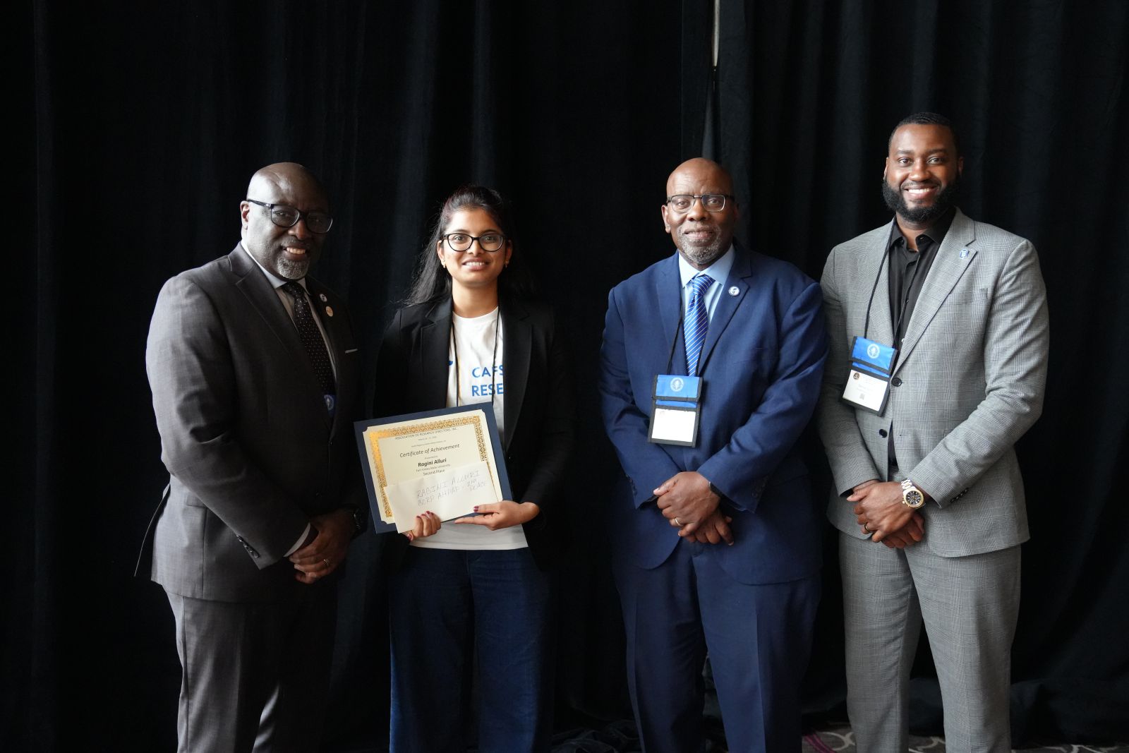 Student with her award and administrators.