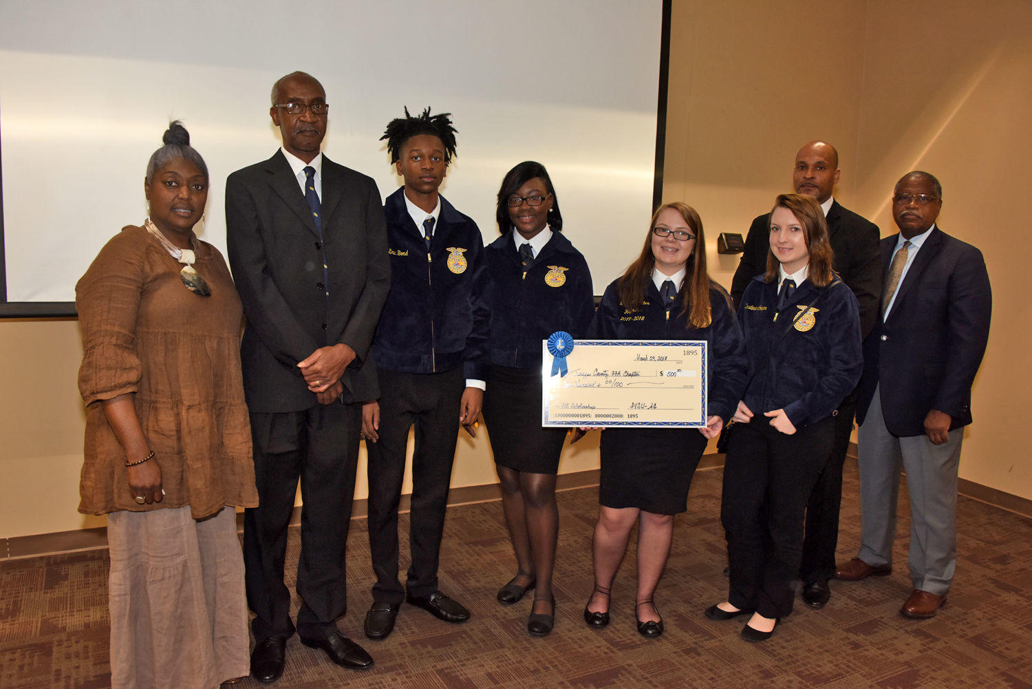 Terralon Chaney (far left), FVSU Twiggs County Extension agent and Dr. Mark Latimore Jr. (far right), FVSU Extension administrator, present the Twiggs County High School Future Farmers of America (FFA) chapter the FFA Scholarship Award.