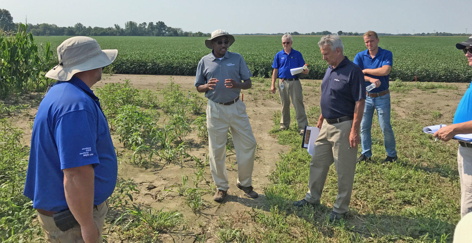 Hunter makes a presentation in the field as onlookers pay close attention.