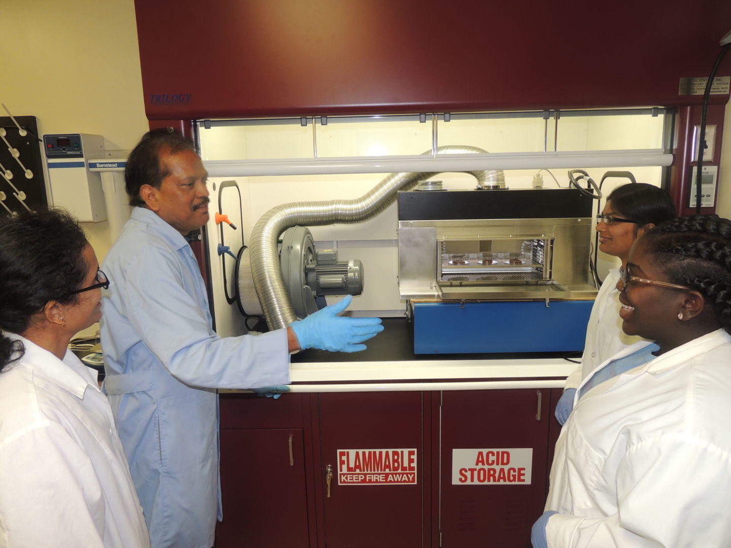 Dr. Ajit Mahapatra speaks to students and research assistant about the benefits of using UV light to decontaminate food surfaces.