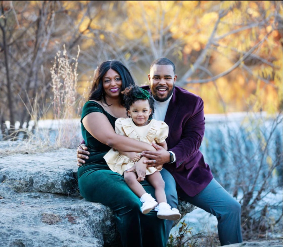 John Levell Miles smiles as he poses with his wife, Raven, and daughter, River. They also have a son, Jett.