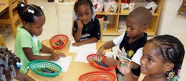 Head Start students enjoying coloring