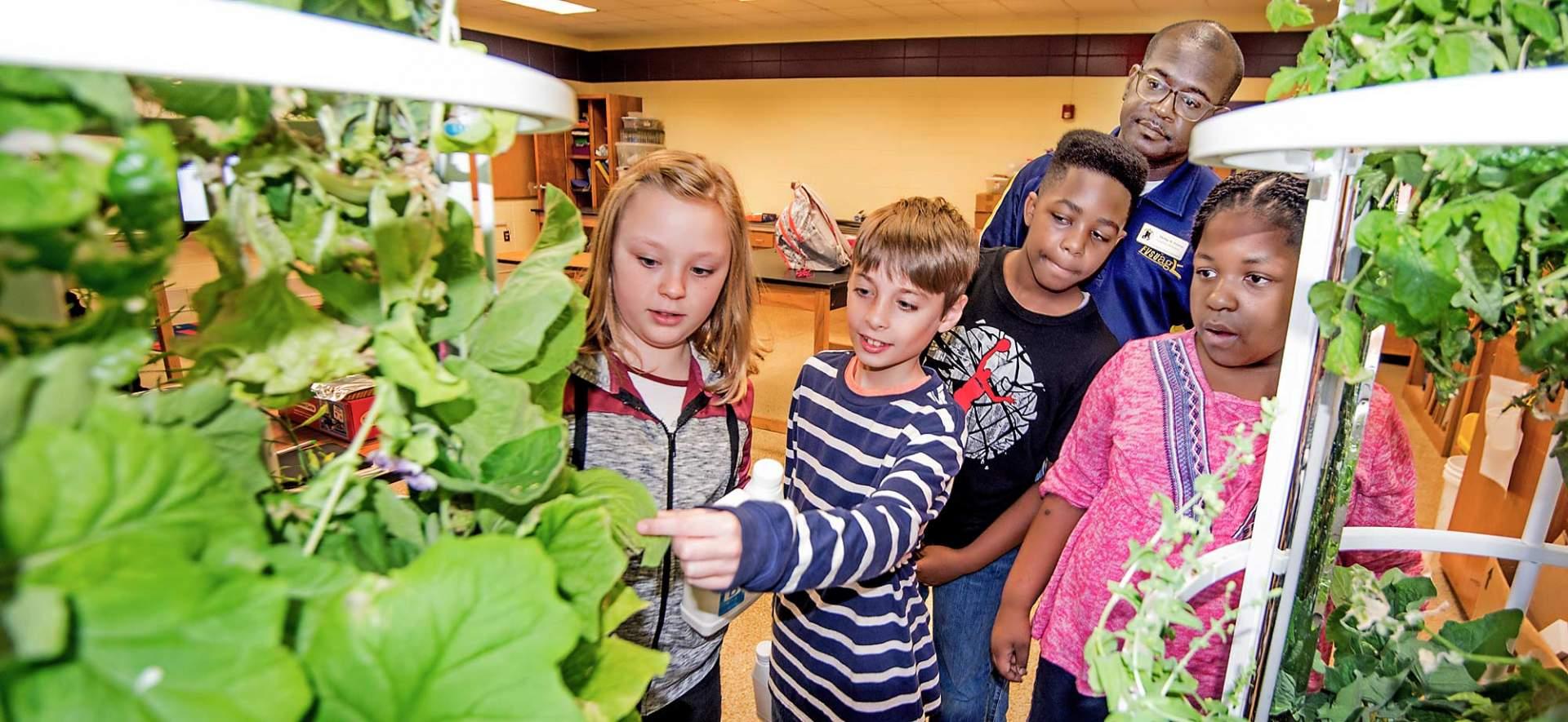 Twiggs County 4-H students view the aeroponic towers housed at Jeffersonville Elementary School.