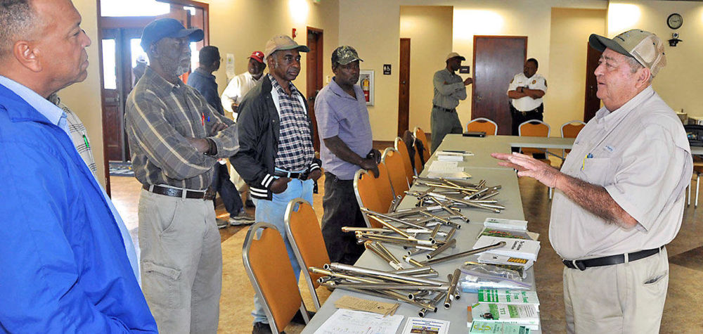 Edward Bulcher (right), district manager of Grower Mineral Solutions, discusses soil sample techniques with Fort Valley State University Extension agents and farmers at the Agricultural Technology Conference Center.