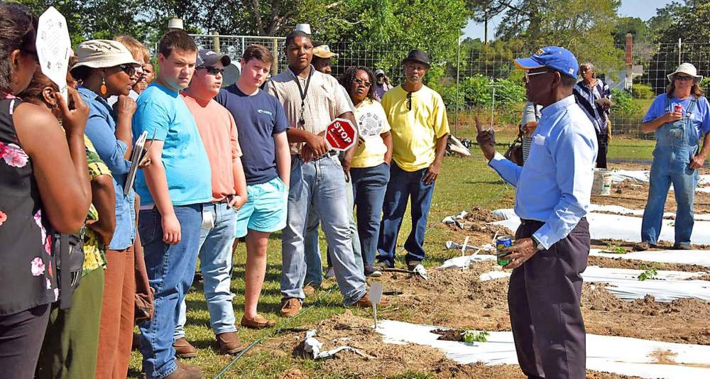 Dr. James Brown, Fort Valley State University's agricultural and natural resources program leader, discusses farming techniques with attendees during the Farm and Field Day at the Village Community Garden in Sylvester May 10.