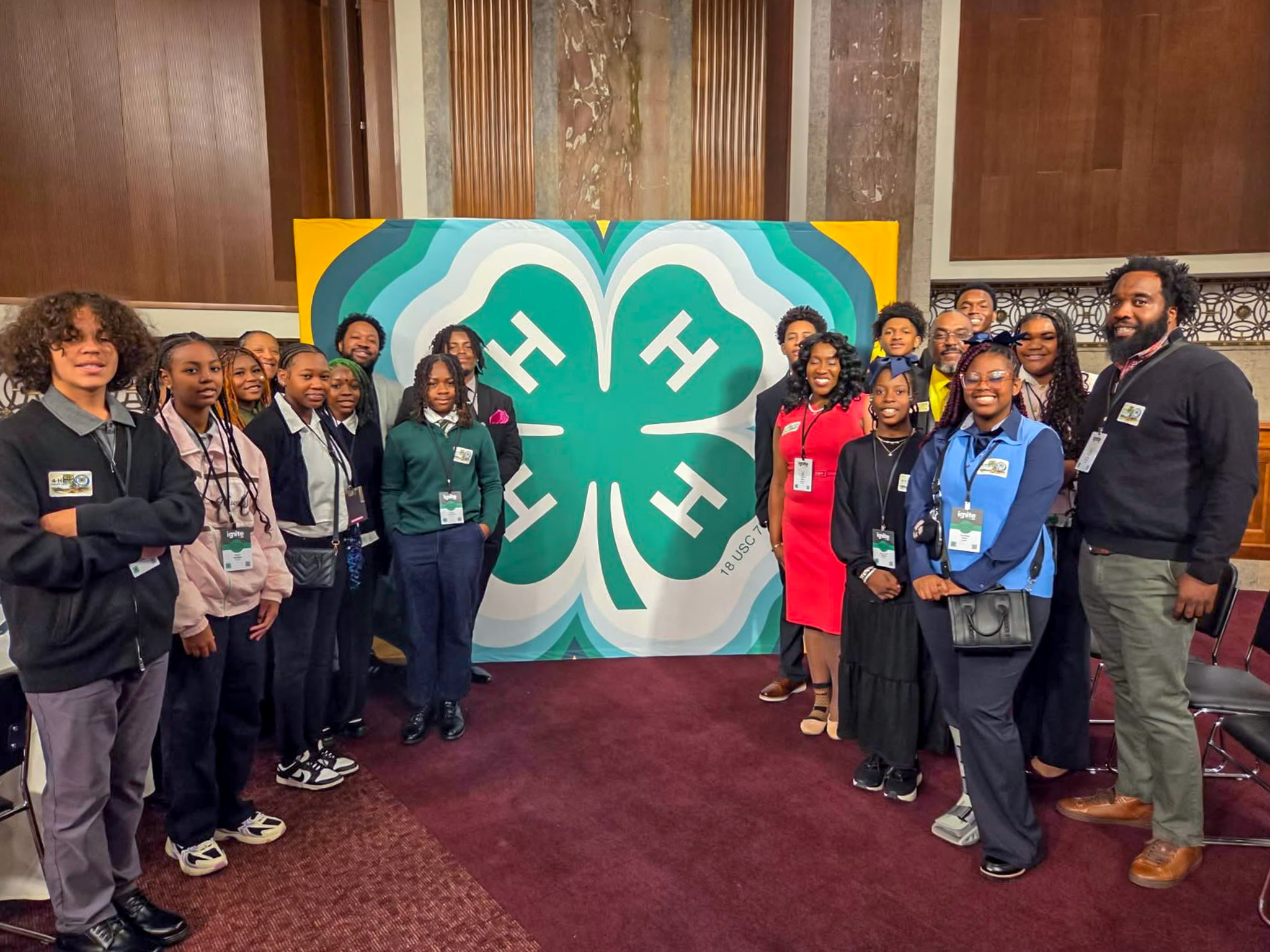 Group in front of 4-H sign.