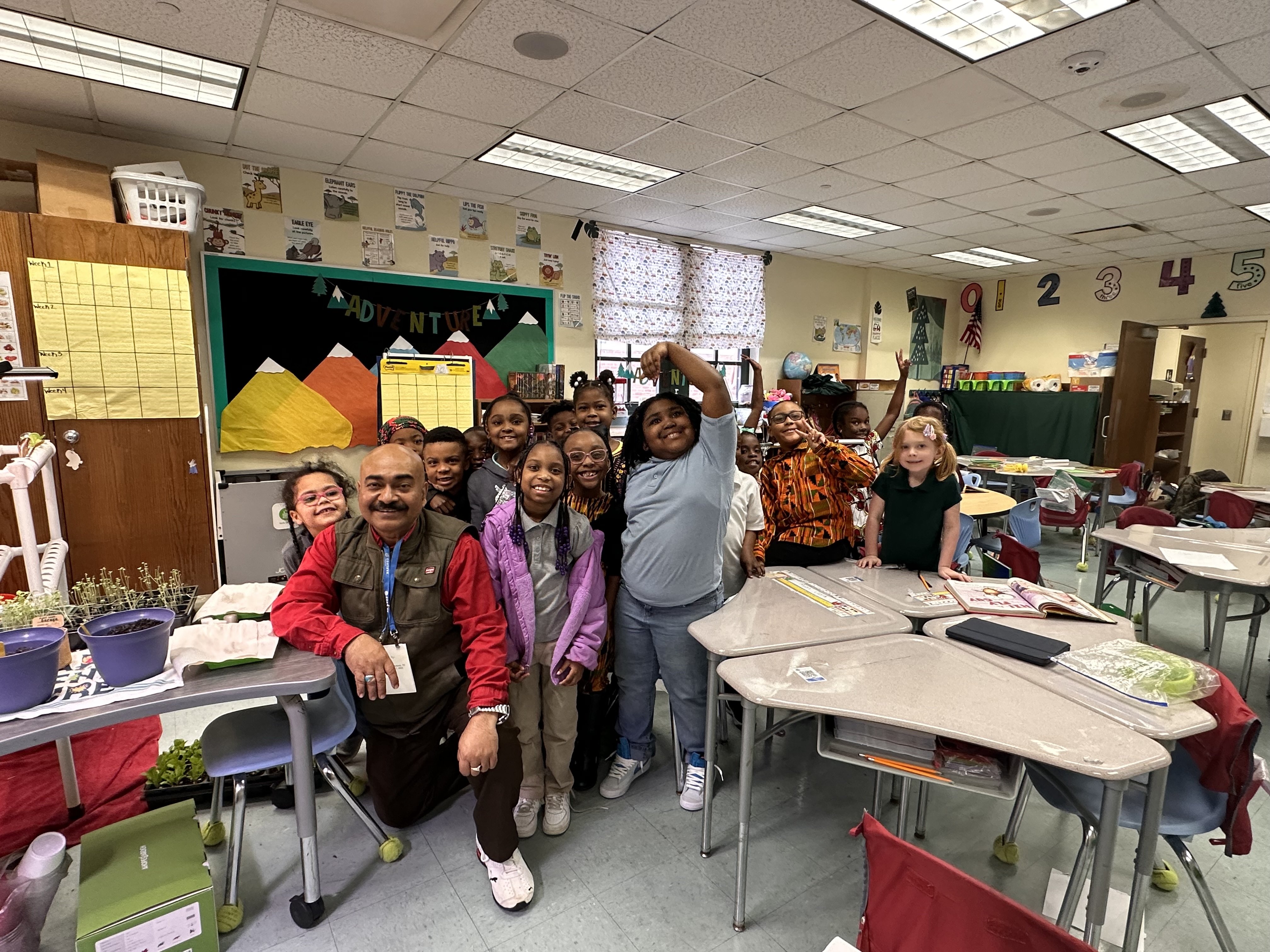 Researcher Bipul Biswas, Ph.D., smiles with first graders.